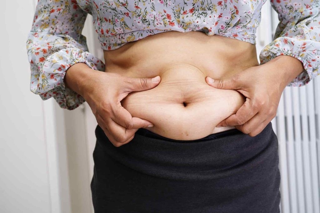 affordability-of-liposuction-turkey-woman-holding-her-belly